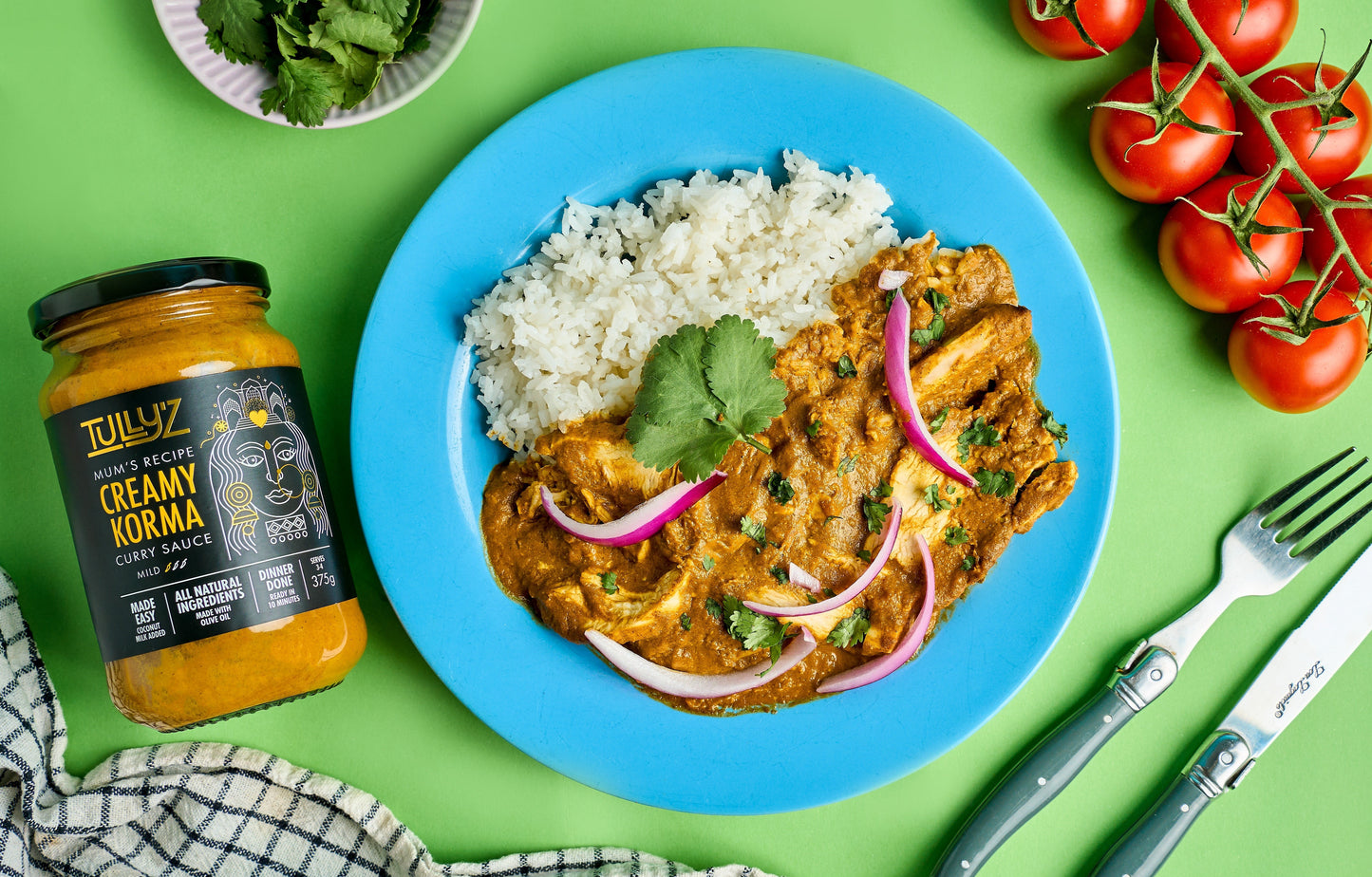 Creamy Korma Chicken Curry served with fresh red onion and coriander garnish.