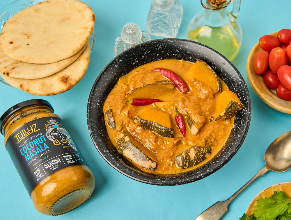 Coconut Masala Pumpkin Curry garnished with fresh coriander and sliced chilis.