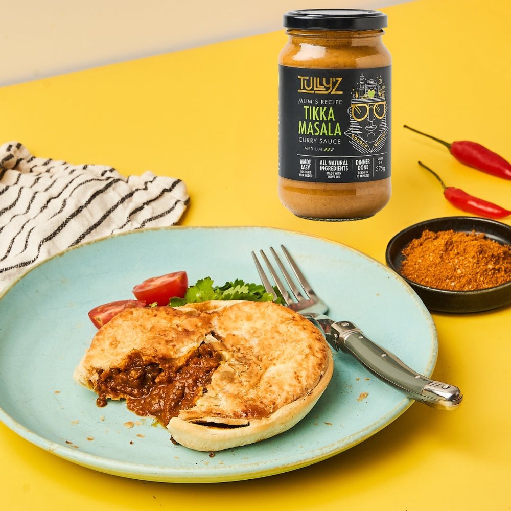 Tikka Masala Curry Beef Pie with a golden puff pastry crust, garnished with fresh coriander